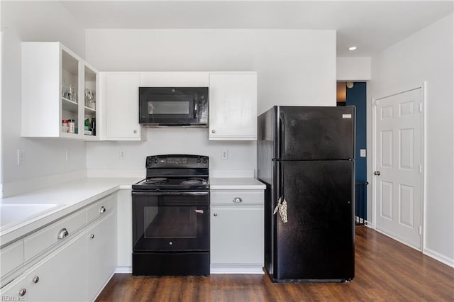 kitchen featuring black appliances, white cabinets, light countertops, and dark wood-type flooring