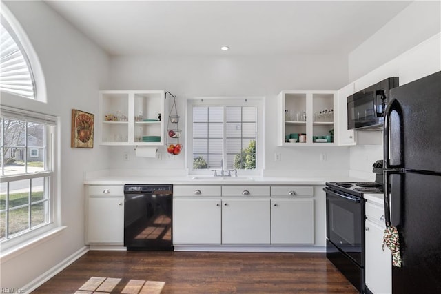 kitchen with a sink, black appliances, open shelves, white cabinetry, and dark wood-style flooring