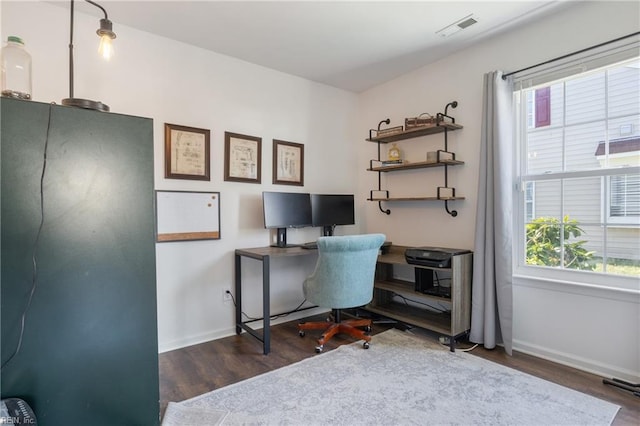 office space with visible vents, baseboards, and wood finished floors