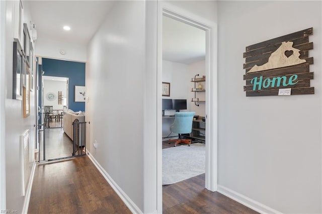 corridor featuring recessed lighting, baseboards, and dark wood-style flooring