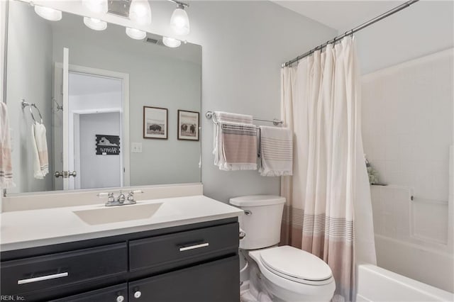 bathroom with shower / bath combo with shower curtain, toilet, and vanity