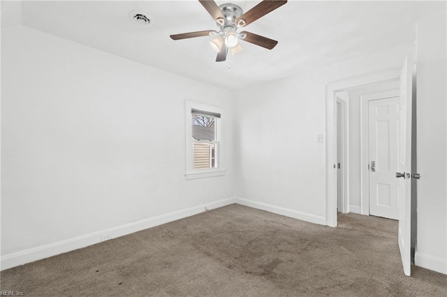 unfurnished room with visible vents, carpet, baseboards, and ceiling fan