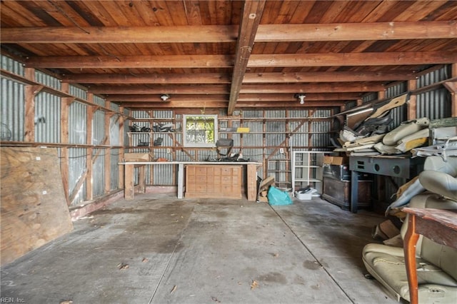 interior space with beam ceiling and concrete floors