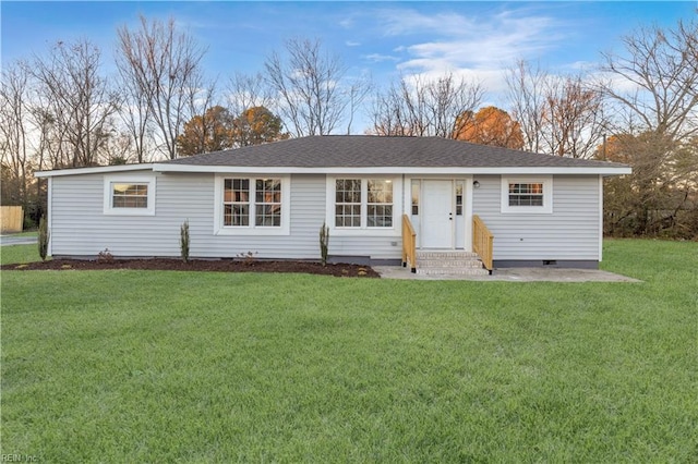 view of front facade with a front yard, crawl space, and a shingled roof