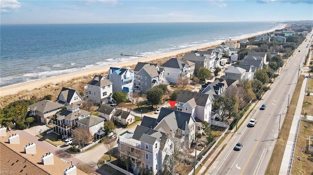 aerial view featuring a residential view, a view of the beach, and a water view