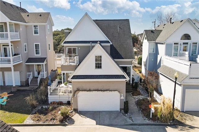 view of front of house featuring board and batten siding, concrete driveway, a garage, and a shingled roof