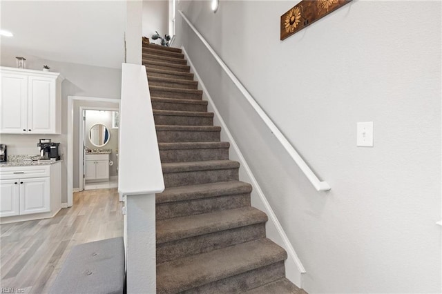 stairs featuring wood finished floors