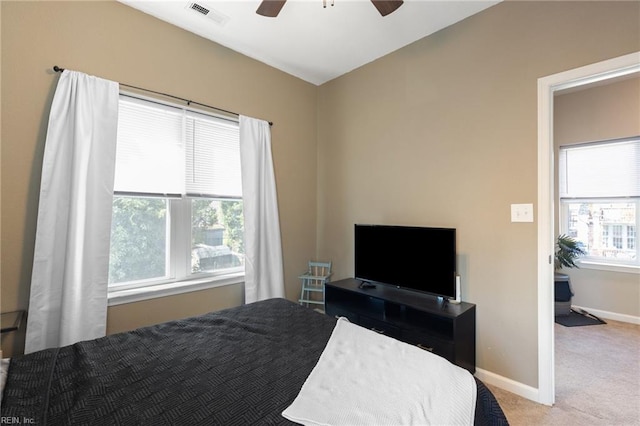 carpeted bedroom featuring visible vents, a ceiling fan, and baseboards