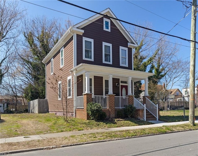 view of front of house with fence and covered porch