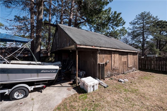 view of outbuilding featuring an outdoor structure and fence