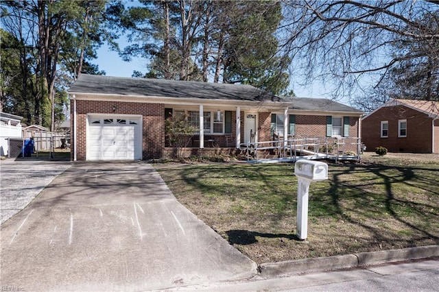 ranch-style house featuring brick siding, concrete driveway, a front yard, covered porch, and an attached garage