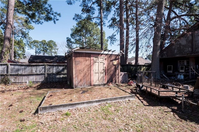 view of shed featuring fence