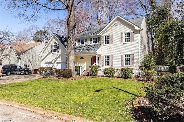 view of front facade with a garage, driveway, and a front yard