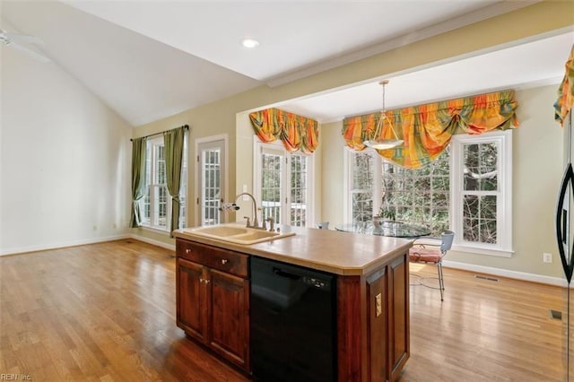 kitchen with black dishwasher, wood finished floors, baseboards, and a sink