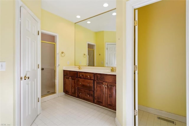 full bathroom with visible vents, a stall shower, a sink, recessed lighting, and double vanity