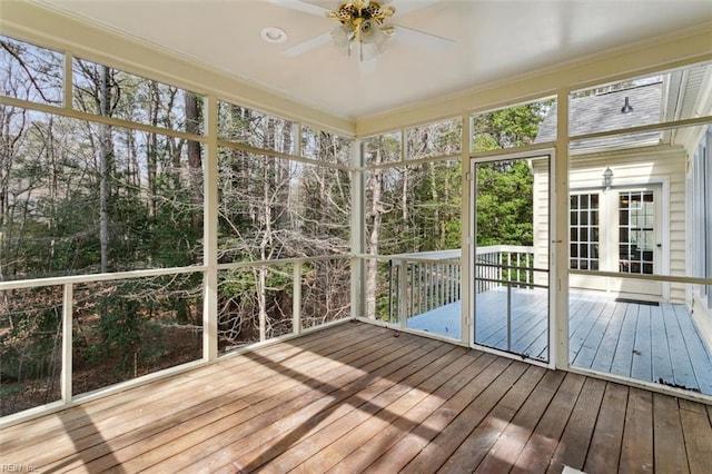 unfurnished sunroom with a ceiling fan