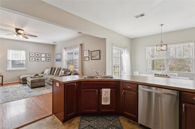 kitchen with visible vents, a sink, dishwasher, decorative light fixtures, and open floor plan