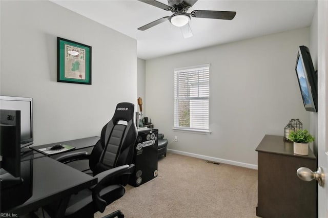 carpeted office space with visible vents, ceiling fan, and baseboards