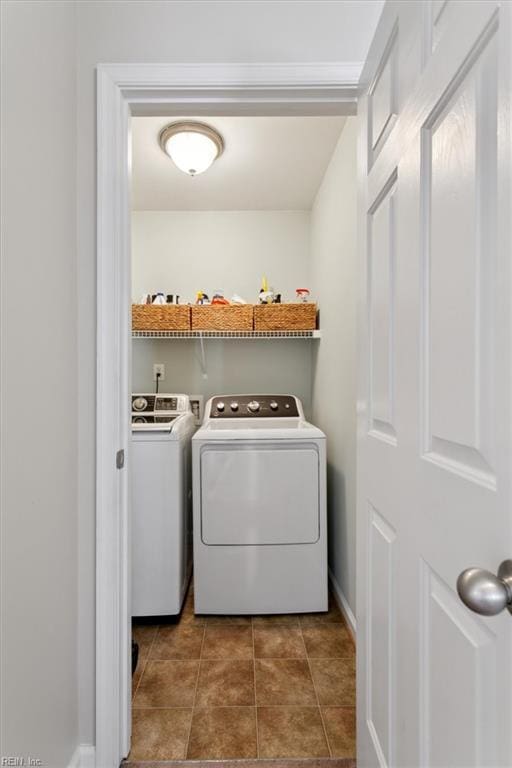 laundry area with washer and dryer, laundry area, and tile patterned flooring