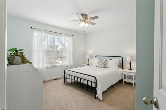 carpeted bedroom with a ceiling fan and baseboards