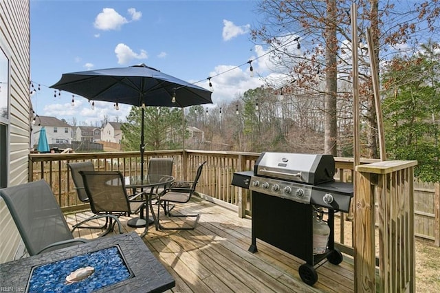 deck with grilling area and outdoor dining area