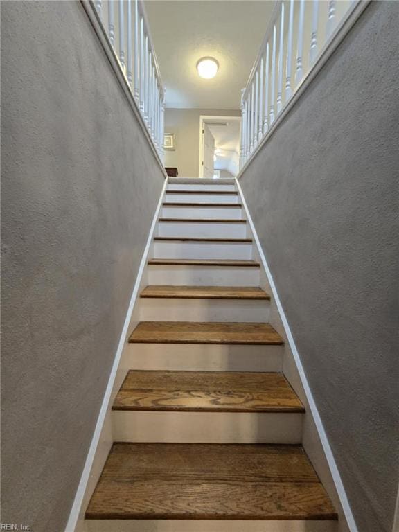 staircase with a textured wall