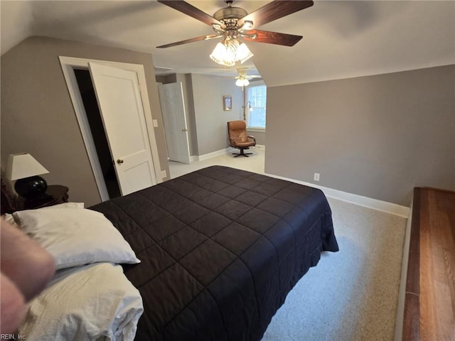 carpeted bedroom featuring a ceiling fan, lofted ceiling, and baseboards