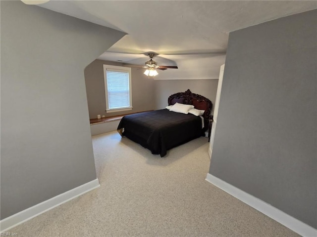 bedroom with baseboards, carpet, and a ceiling fan