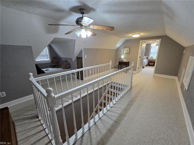 additional living space with baseboards, carpet, and vaulted ceiling