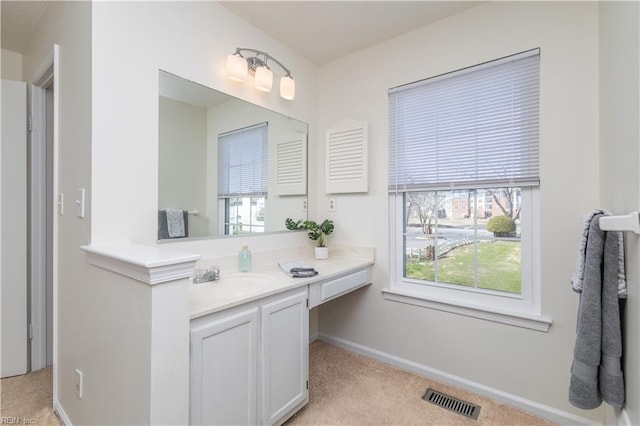 bathroom featuring vanity, baseboards, and visible vents