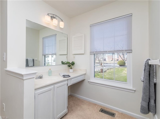 bathroom with visible vents, baseboards, and vanity