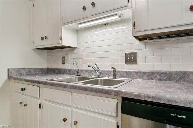 kitchen with a sink, white cabinets, decorative backsplash, and stainless steel dishwasher