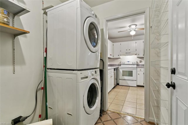 clothes washing area with laundry area, light tile patterned flooring, a ceiling fan, and stacked washing maching and dryer