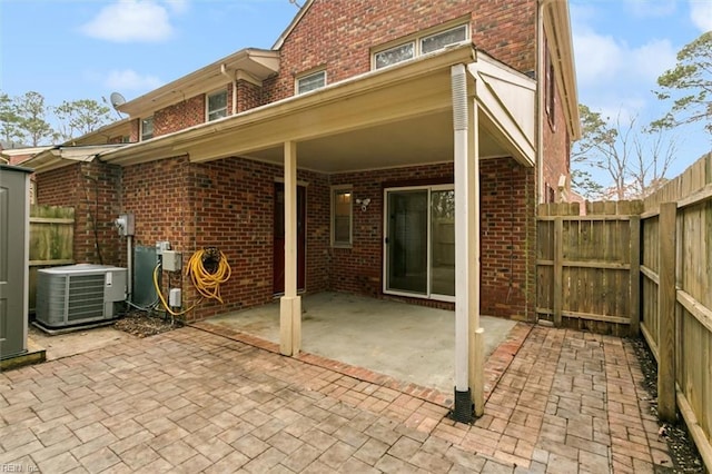 view of patio featuring central air condition unit and fence