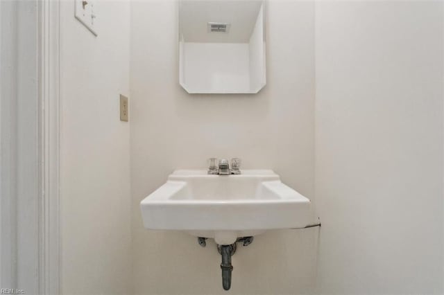 bathroom featuring visible vents and a sink