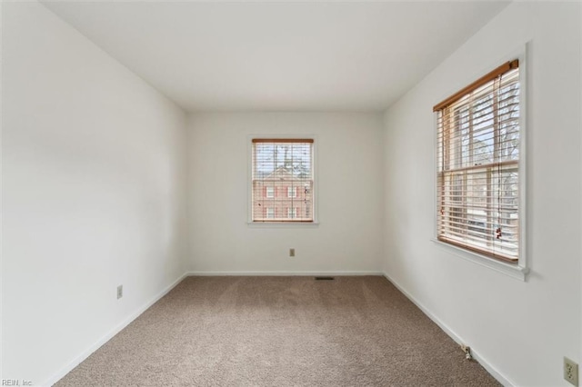 empty room with carpet flooring and baseboards