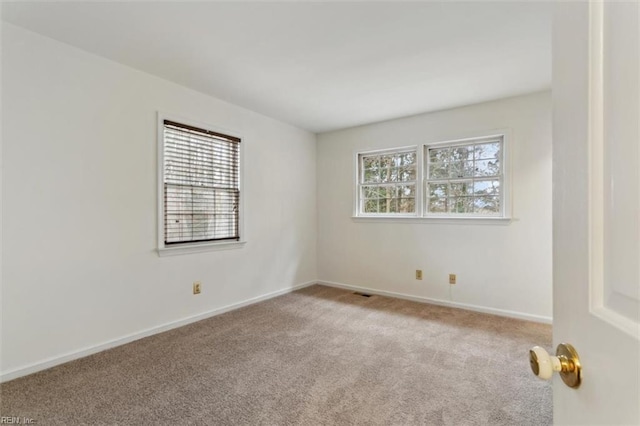 empty room with baseboards and carpet floors