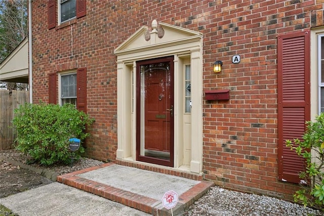 view of exterior entry featuring brick siding