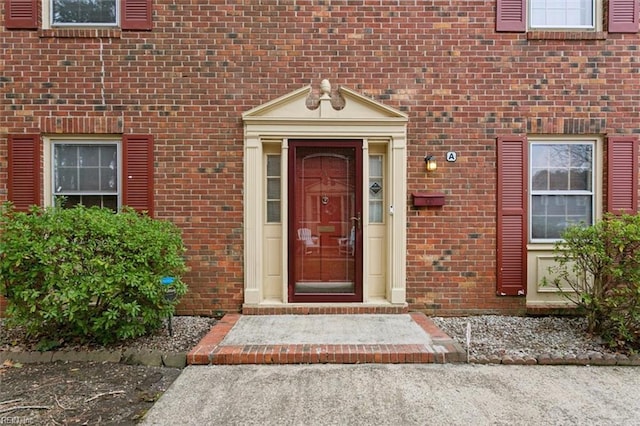 property entrance with brick siding