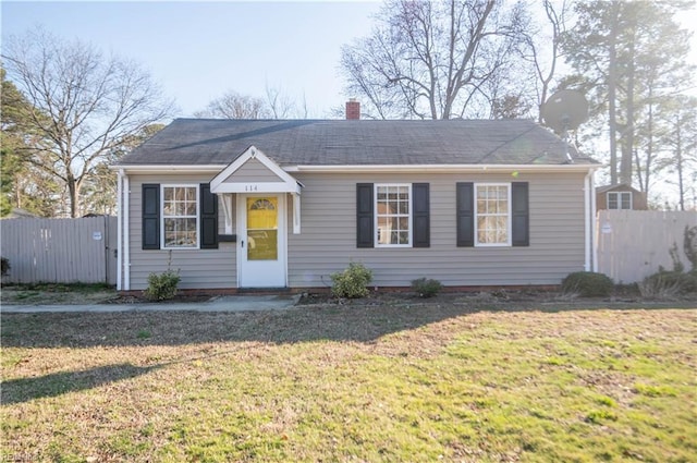 bungalow-style home featuring a front lawn, fence, and a chimney