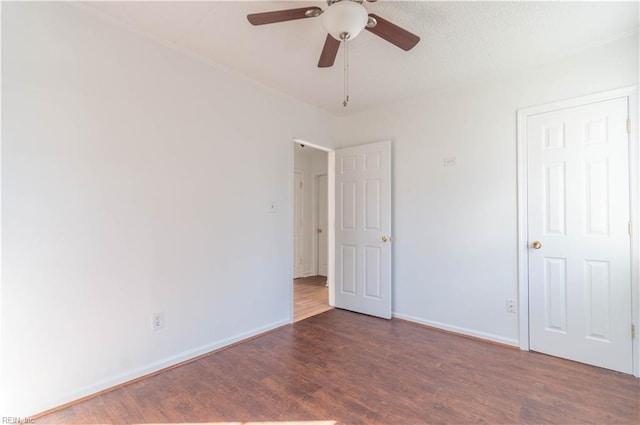 unfurnished bedroom featuring ceiling fan, baseboards, and wood finished floors