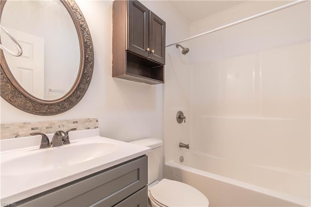 full bathroom featuring backsplash, toilet, vanity, and washtub / shower combination