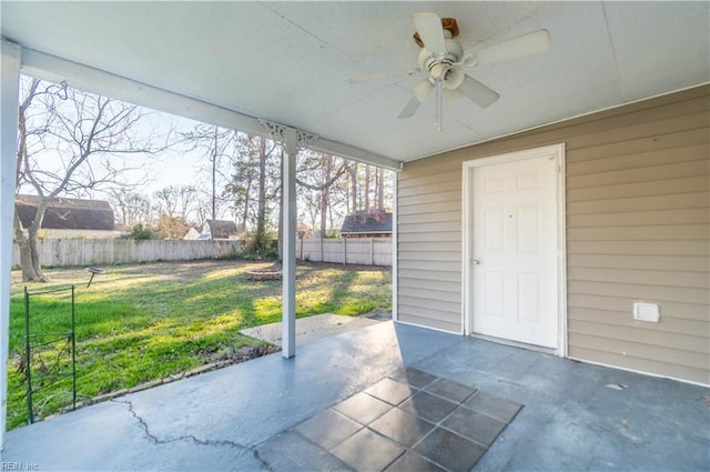 unfurnished sunroom featuring ceiling fan