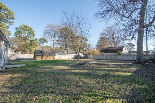 view of yard with an outbuilding and a fenced backyard