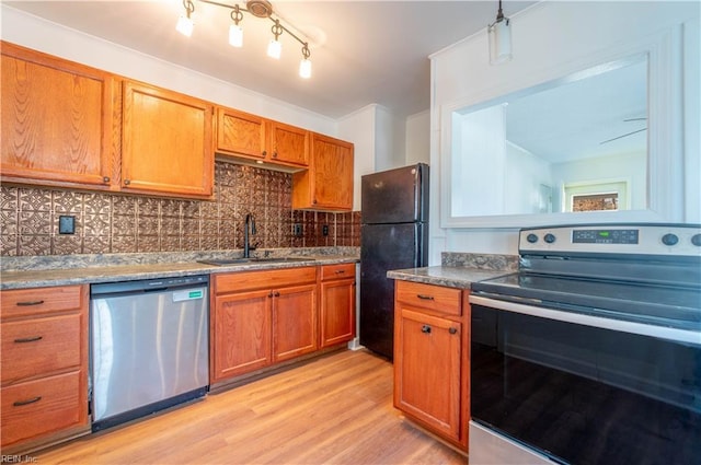 kitchen with light wood-type flooring, a sink, tasteful backsplash, stainless steel appliances, and brown cabinetry