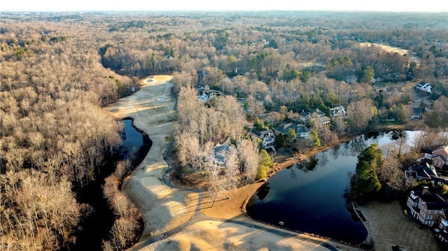 drone / aerial view with a forest view and a water view