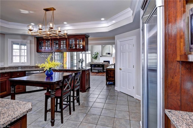 dining space featuring a raised ceiling, light tile patterned floors, recessed lighting, and ornamental molding