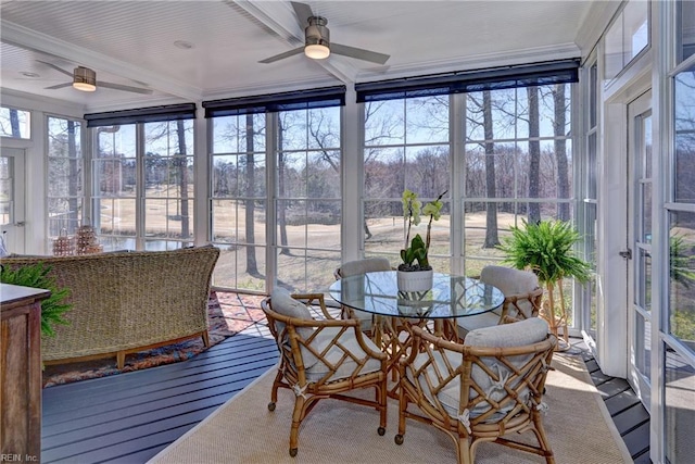 sunroom / solarium with a ceiling fan