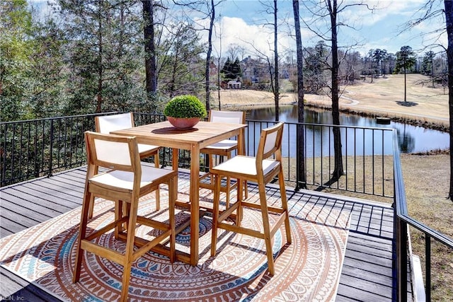 wooden terrace featuring a water view