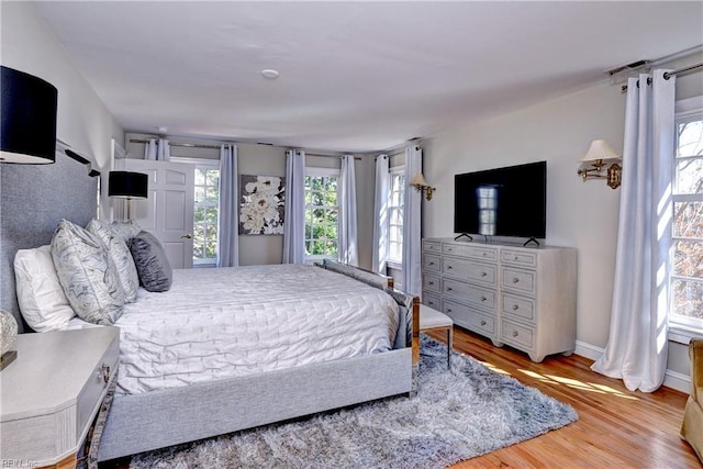 bedroom featuring wood finished floors and baseboards